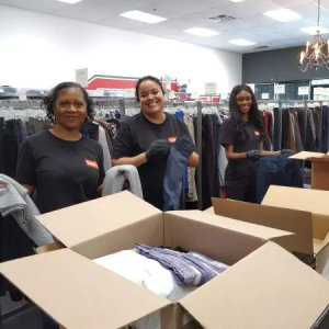 People folding clothes and putting them in boxes