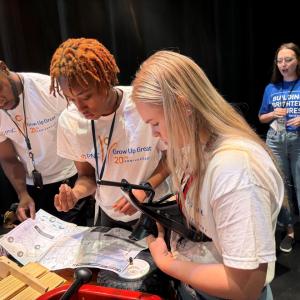 Interns and volunteers working together to assemble bikes and wagons.