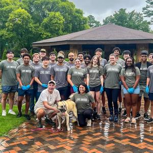 The group of volunteers posed in a park setting.