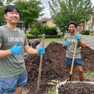 Two intern volunteers gardening.