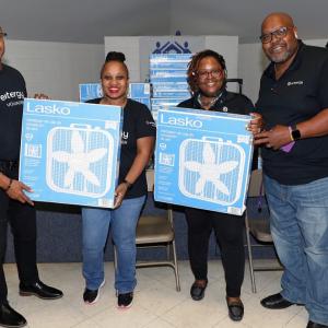 Volunteers posed holding boxed fans.