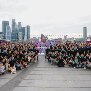 A large group of volunteers posed outside