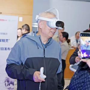 A person using a vr headset and controller in a room of others.