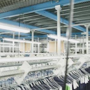 A warehouse with rows of racks of hanging clothing