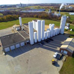 Aerial view of a warehouse, multiple buildings and storage towers.