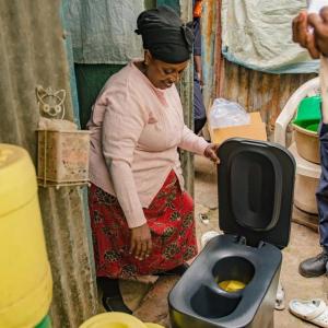 A person looking over a Loope toilet