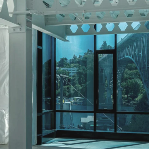 building with floor to ceiling windows looking out to bridge