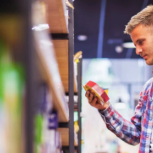 A customer looking at a product from a shelf