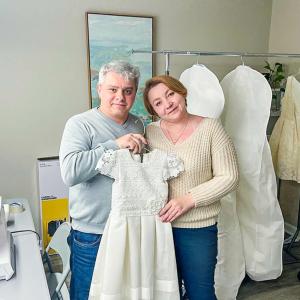 Mykola and Olena Vyshyvanyuk show off a recent dress created for a wedding.