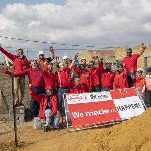 Group shot of people holding Henkel banner