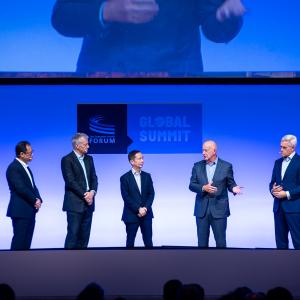 Five leaders in line on a stage