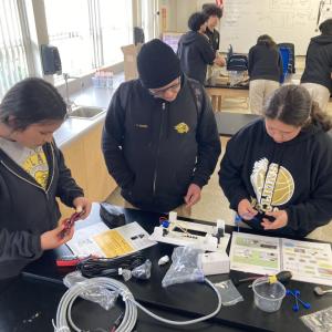 A team of students working on solar battery kit.