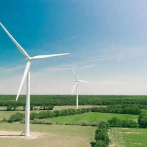 Wind turbines in an open area, clear sunny weather.