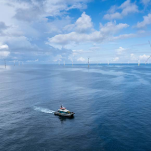 Boat in the ocean surrounded by wind turbines