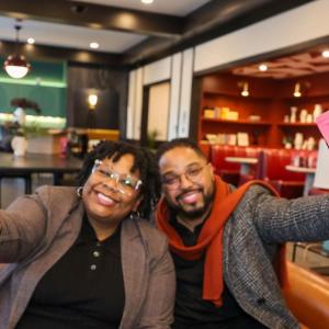 Nikisha Bailey and Matt Nam holding bags of "Win Win" coffee.