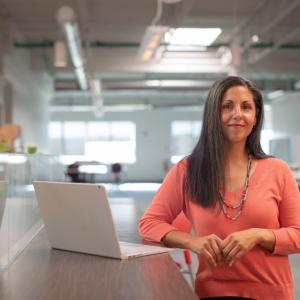 woman standing next to a computer