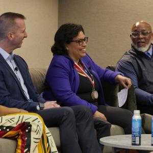 people sat next to each other on chairs 