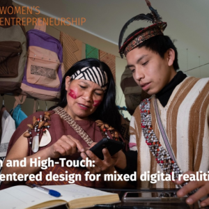 two people looking at a device in a shop, an open book on the table in front of them. "High-tech and High-touch: Women centered design for mixed digital realities."