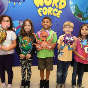 Five kids with crafts in front of "Word Force" banner