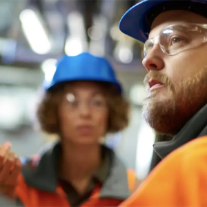 2 people wearing hardhats and safety glasses
