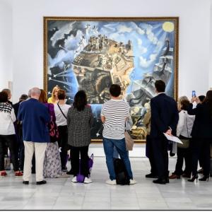 A small crowd admiring a large painting