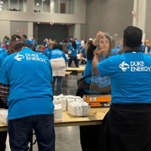 Volunteers wrapping diapers in bundles.