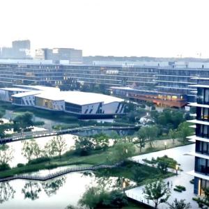 aerial view of Alibaba campus, water featured centrally with walking bridges
