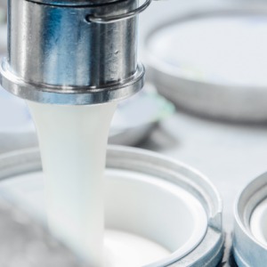 close up of a dairy product being filled into containers
