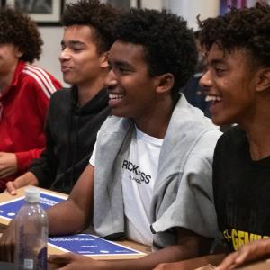 Young men from the Hidden Genius Project in Oakland receiving their free personal laptops.
