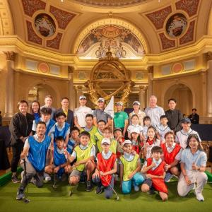 A group of adults and children posed in a group inside a fancy building.