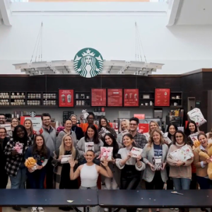 group of people standing in front of a Starbucks