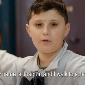 Image of child with the caption, "My name is Joaquin and I walk to school"