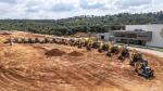 Construction equipment lined up outside CNH buiding