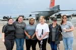 Kay Goke in group photo in front of large plane
