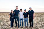 5 people standing in a field