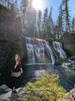 Bliss Buter-Thompson standing outside near a waterfall