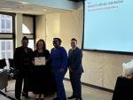 KeyBank and TAP representatives shown with the certificate.