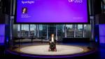 Man in wheelchair talking on stage 