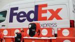 Backpacks and Direct Relief boxes in front of a FedEx Express van