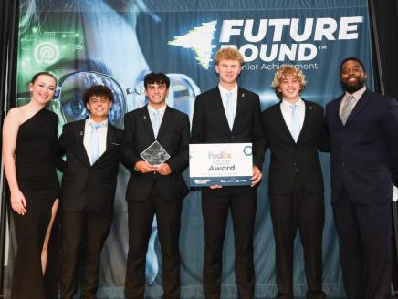 6 people on stage accepting an award