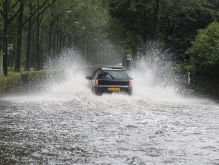 A car driving thorough a flooded street
