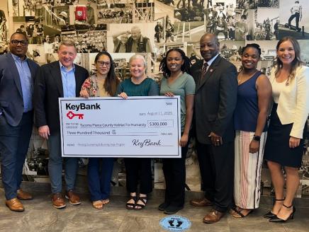 Representatives from KeyBank and Habitat for Humanity shown with a $300,000 grant check.