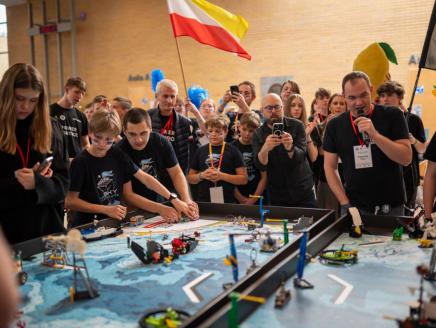 People compete at robotics league
