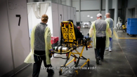 Person laid on a stretcher surrounded by medical staff