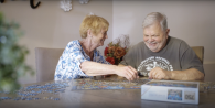 Marion and her husband working on a jigsaw puzzle together