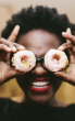 Holding two cookies as eyes