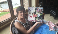 Jill Stair holding up a collage of photos