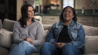 Two people seated on a couch.