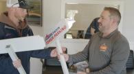 Ron Fisher, right, delivers custom signs made by Fisher Signs & Shirts.