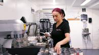 A person grabbing ingredients in a bakery setting.